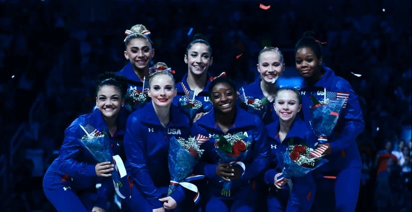 A group of female gymnast posing for camera