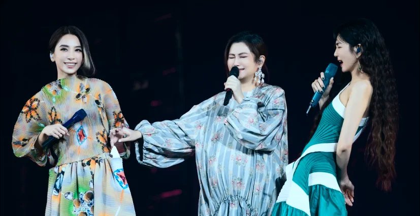 Three male performer in dress singing on stage